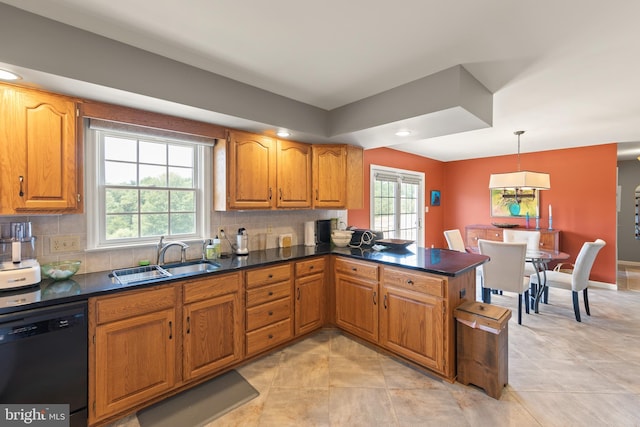 kitchen with pendant lighting, sink, black dishwasher, decorative backsplash, and kitchen peninsula