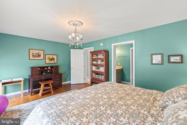 bedroom with dark hardwood / wood-style floors and a notable chandelier