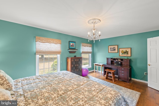 bedroom featuring a notable chandelier and dark wood-type flooring