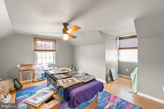 bedroom featuring ceiling fan, vaulted ceiling, and light hardwood / wood-style flooring