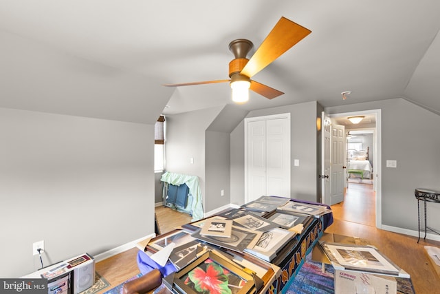 bedroom featuring ceiling fan, vaulted ceiling, a closet, and light hardwood / wood-style flooring