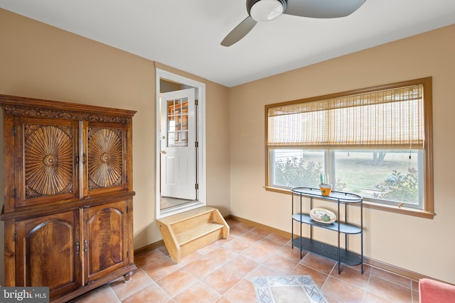 interior space featuring light tile patterned floors and ceiling fan