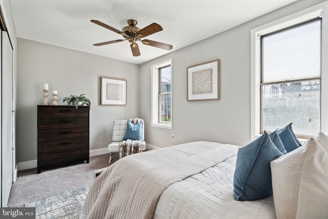 bedroom featuring ceiling fan and light carpet