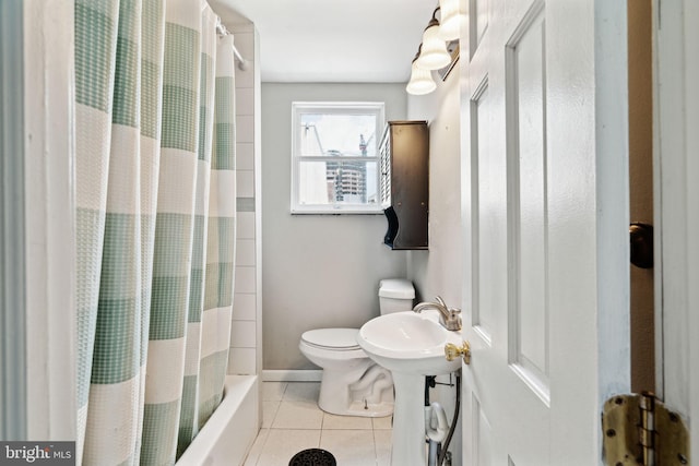 bathroom with toilet, sink, tile patterned floors, and a shower with curtain