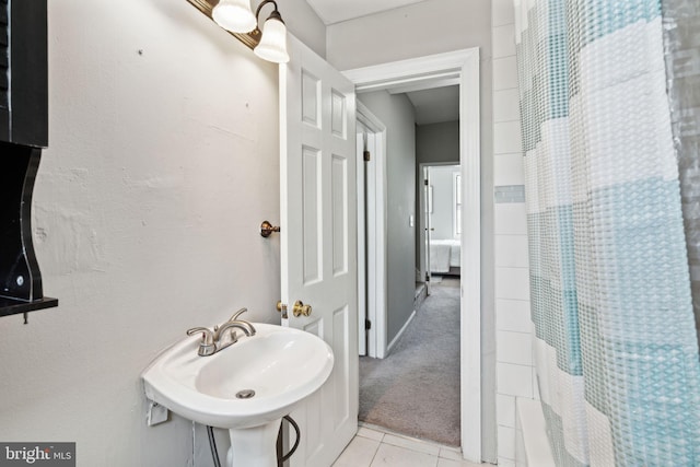 bathroom with tile patterned flooring and sink