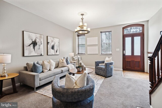 living room with an inviting chandelier and carpet floors