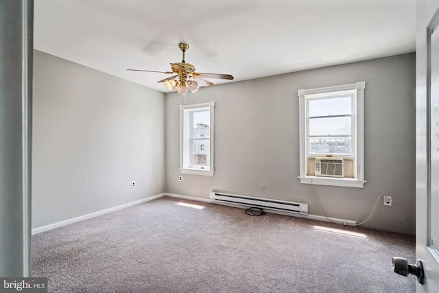 empty room with cooling unit, plenty of natural light, carpet, and a baseboard heating unit