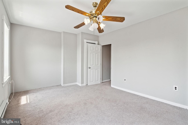 spare room with light colored carpet and ceiling fan