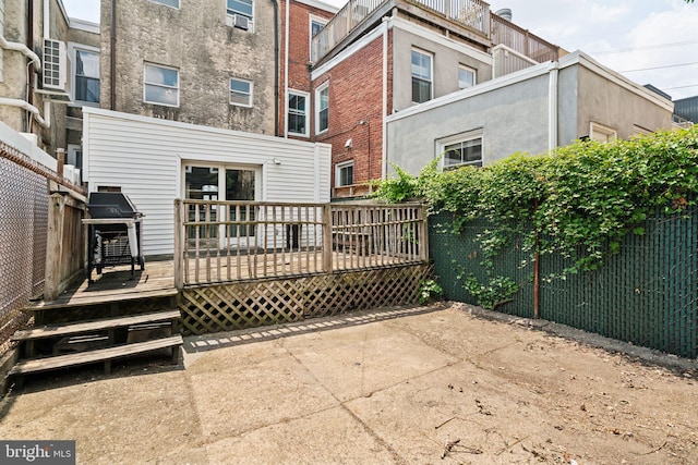 back of house featuring a wooden deck and a patio area