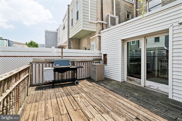 wooden deck with a grill