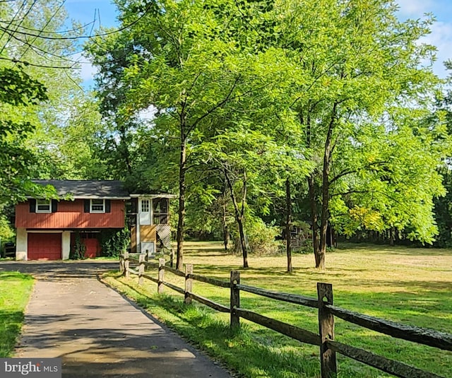 view of front facade with a garage and a front lawn