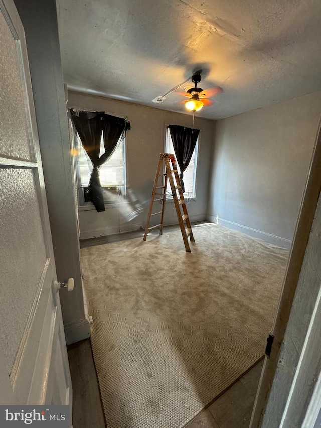 unfurnished bedroom with light carpet and ceiling fan