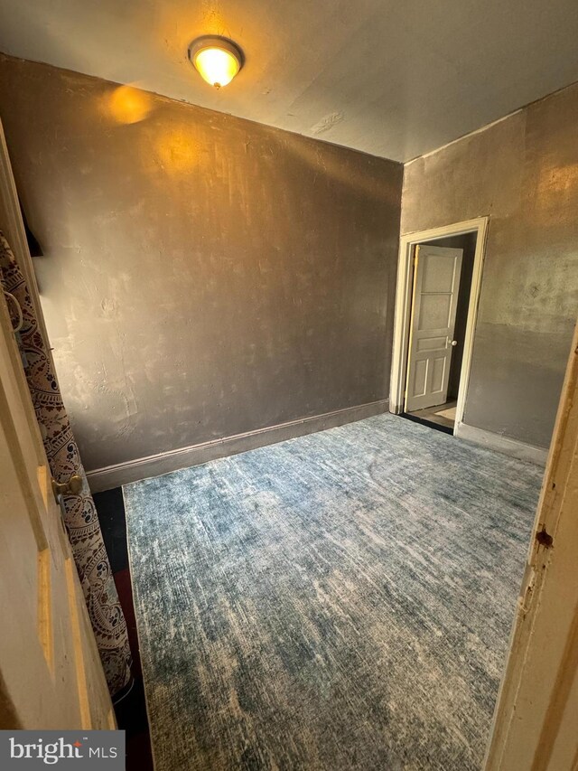 unfurnished room with carpet flooring