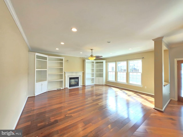 unfurnished living room featuring crown molding, dark wood-type flooring, and ceiling fan