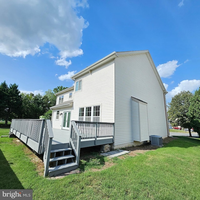 back of house featuring a wooden deck, central AC unit, and a yard