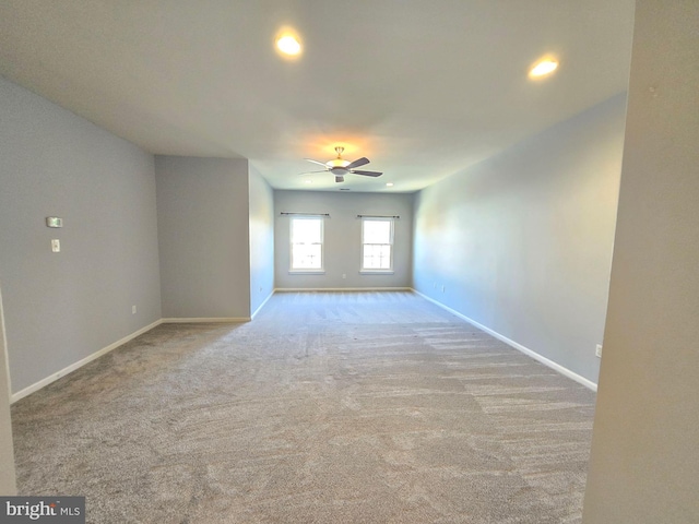 carpeted spare room with ceiling fan