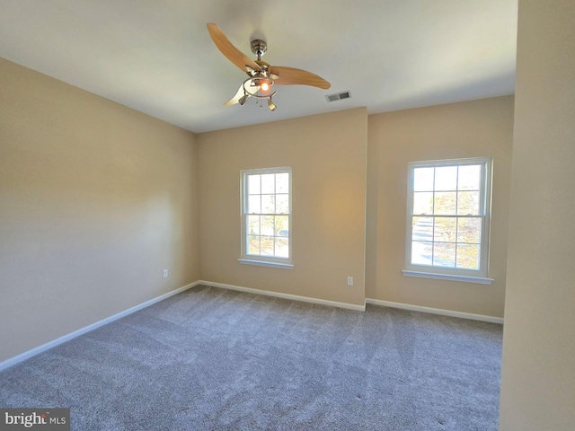 spare room with ceiling fan and carpet flooring