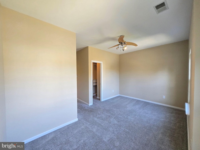 unfurnished room featuring ceiling fan and dark carpet