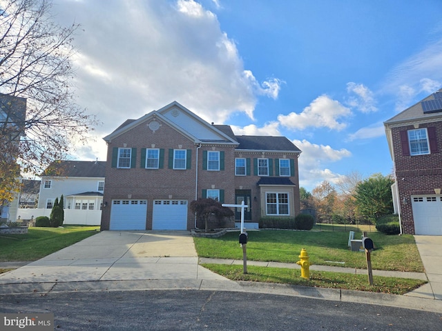 view of front of house with a garage and a front yard