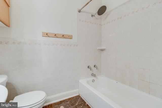 bathroom with tile walls, toilet, and tiled shower / bath