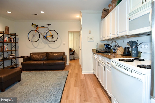 kitchen with sink, crown molding, white cabinets, and white appliances