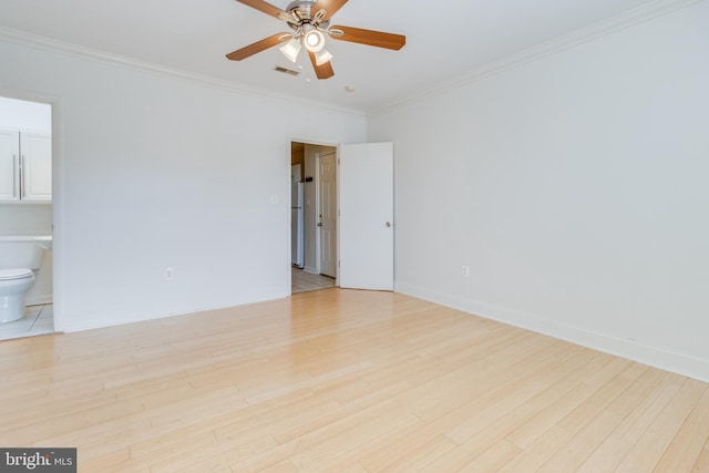 spare room with ceiling fan, light wood-type flooring, and ornamental molding