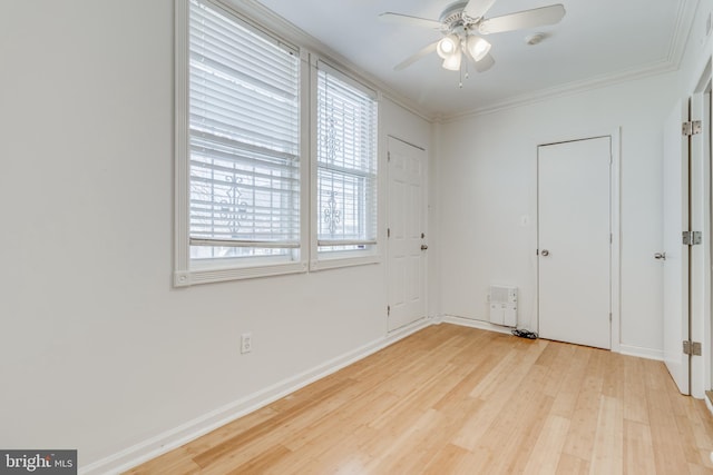 interior space featuring ceiling fan, crown molding, and light hardwood / wood-style flooring