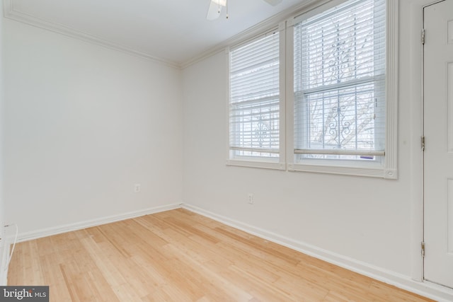 empty room featuring ceiling fan, wood-type flooring, and crown molding