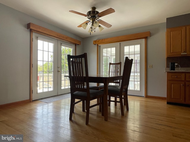 dining area featuring light hardwood / wood-style floors, ceiling fan, and french doors