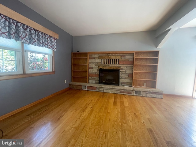 unfurnished living room featuring hardwood / wood-style flooring and a fireplace