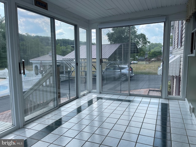 unfurnished sunroom featuring a healthy amount of sunlight