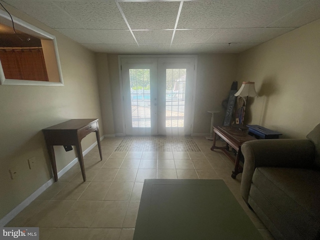 interior space featuring a paneled ceiling and french doors