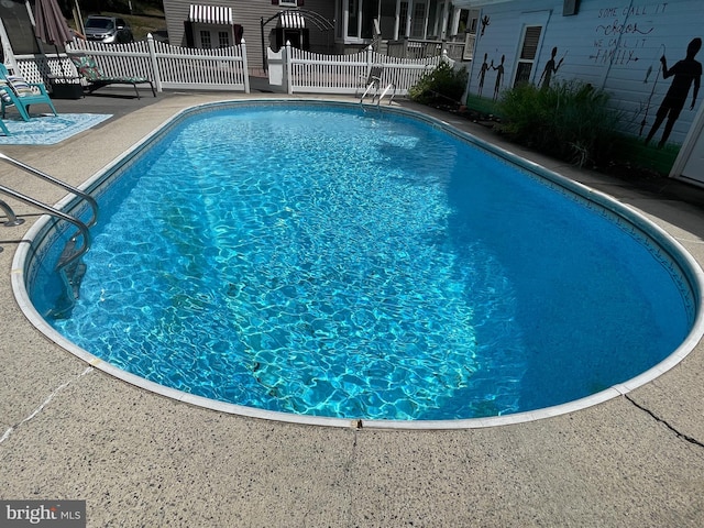 view of swimming pool featuring a patio area