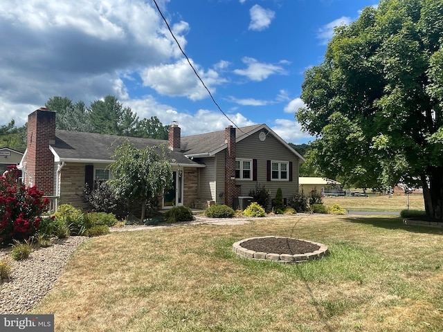 view of front of property featuring cooling unit and a front lawn