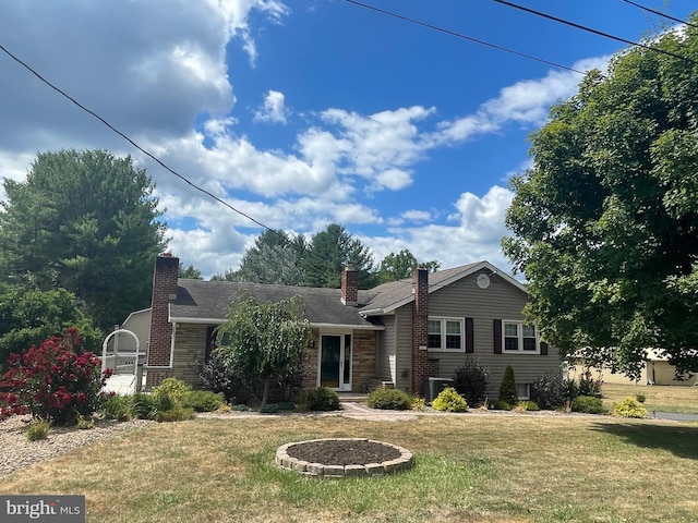 ranch-style home featuring central AC and a front yard