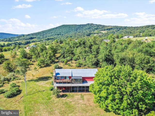 aerial view with a wooded view and a mountain view