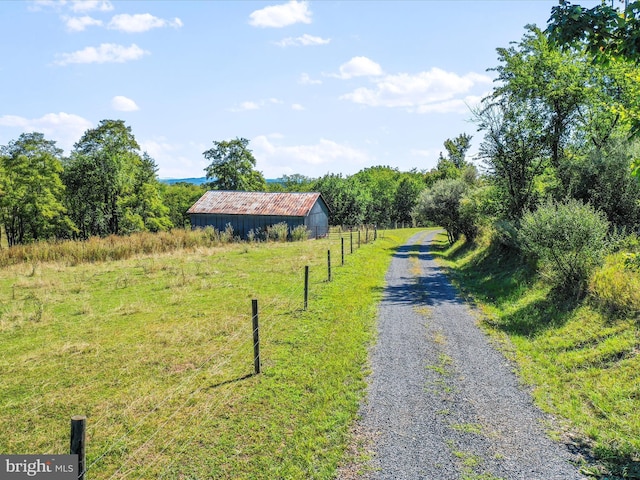 view of street with a rural view and an outbuilding