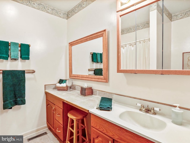 full bath featuring tile patterned floors, visible vents, vanity, and baseboards