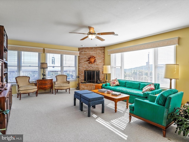carpeted living room with a wealth of natural light, ceiling fan, visible vents, and a brick fireplace