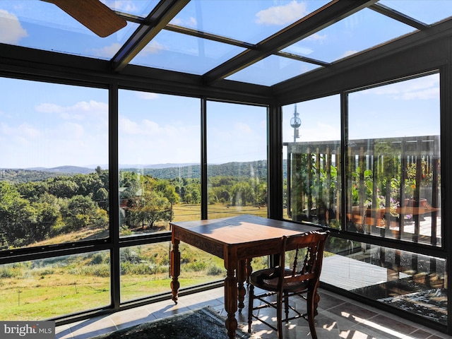 sunroom / solarium with tile patterned floors, a wealth of natural light, and floor to ceiling windows