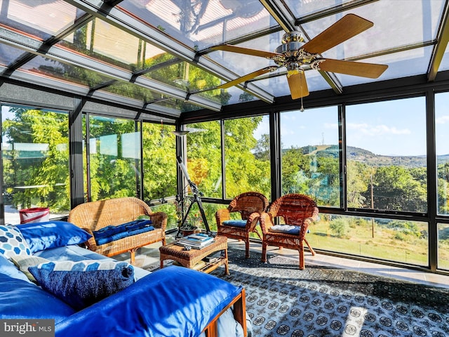 sunroom with outdoor lounge area, plenty of natural light, and a ceiling fan