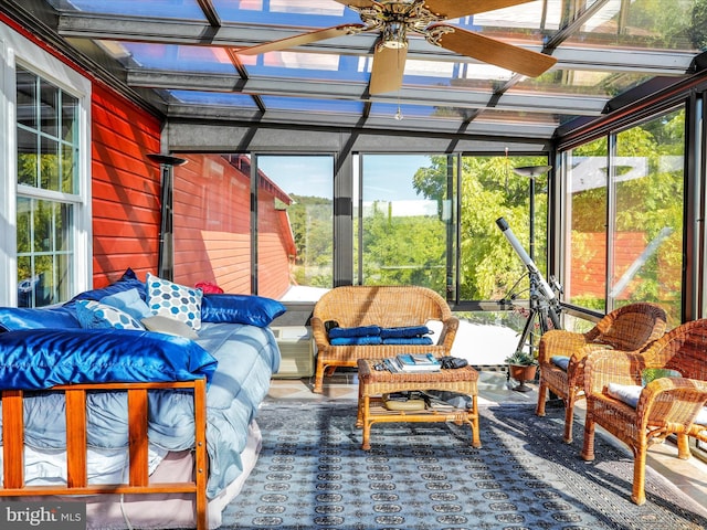 sunroom / solarium with a ceiling fan