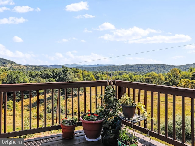 balcony with a mountain view and a view of trees