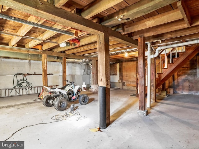unfinished basement featuring stairway
