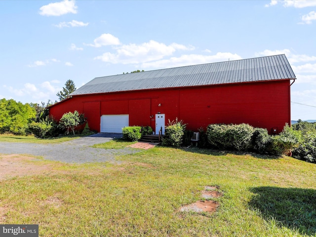 view of pole building with a yard