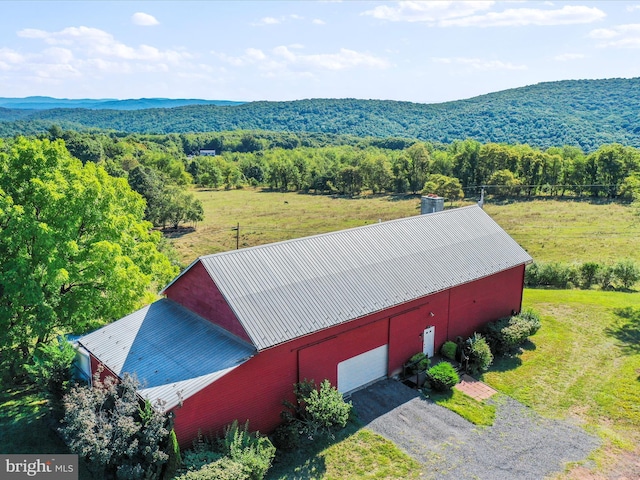 drone / aerial view featuring a wooded view