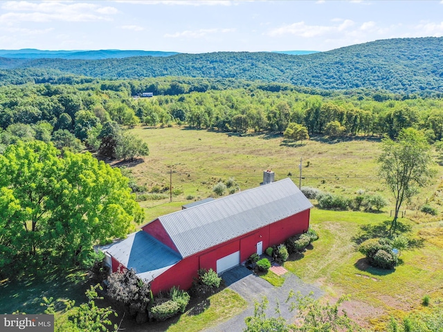 drone / aerial view featuring a mountain view and a view of trees