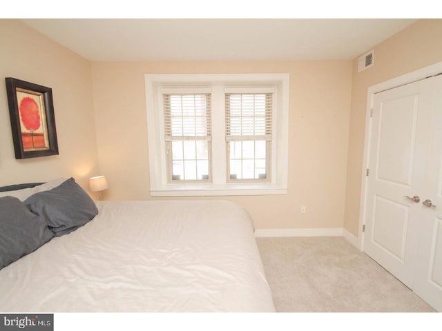 bedroom featuring light carpet