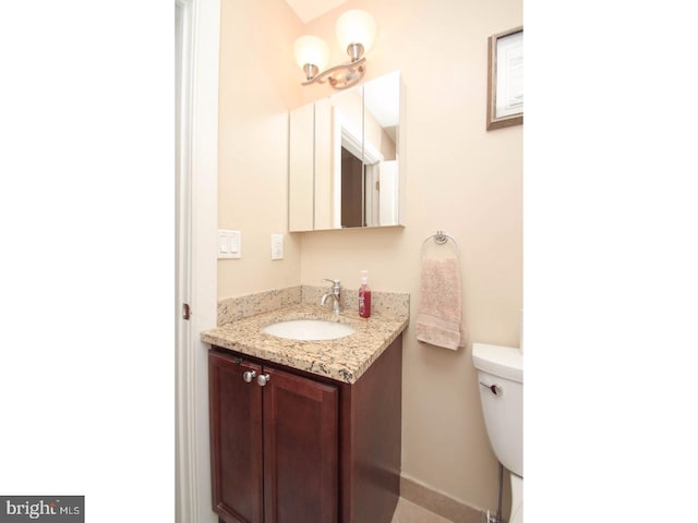 bathroom featuring vanity and toilet