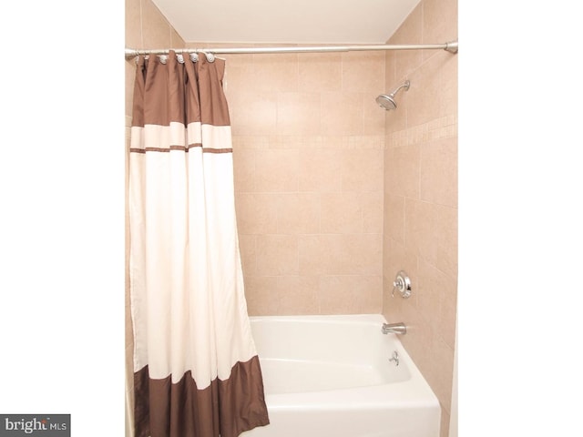 bathroom with shower / bathtub combination with curtain